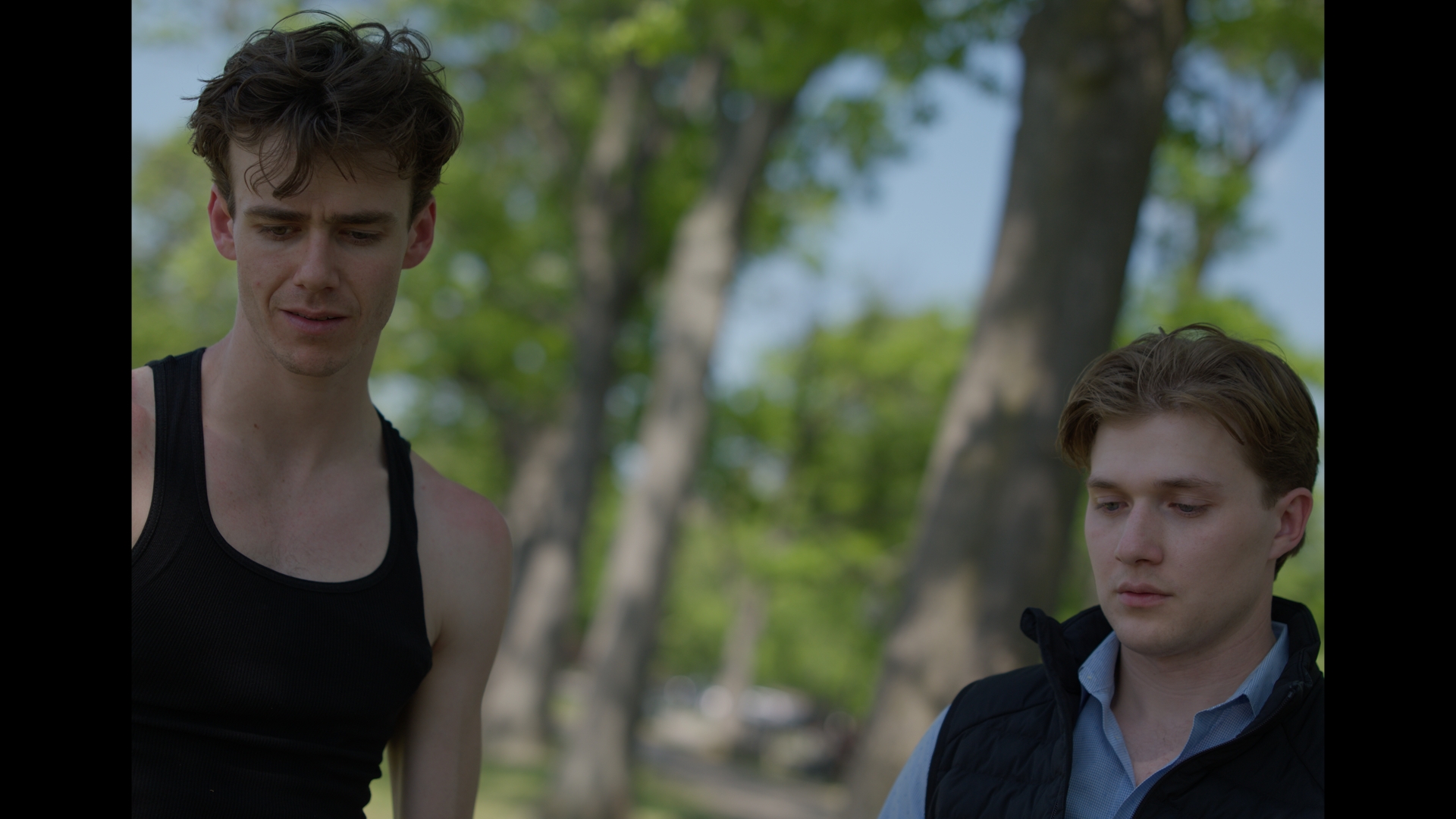 Two brothers standing together outdoors in a scene from Brothers